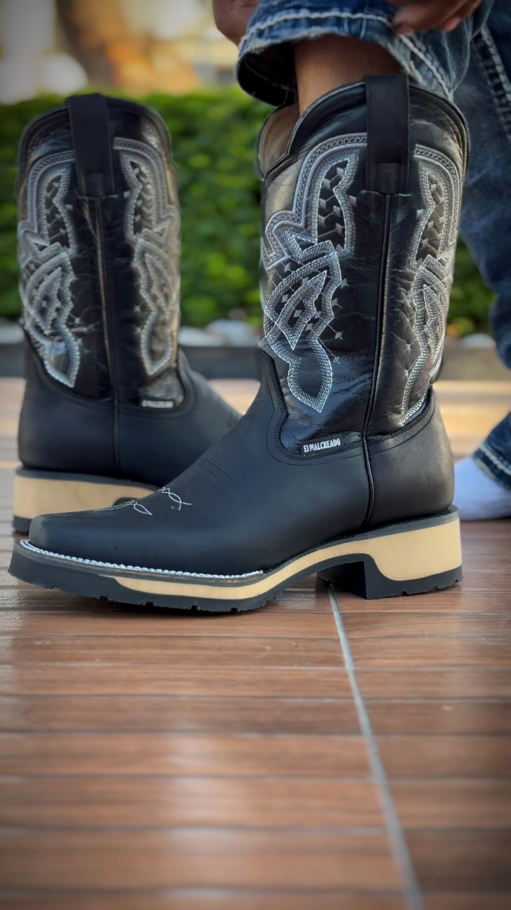 Black cowboy boots with white stitching