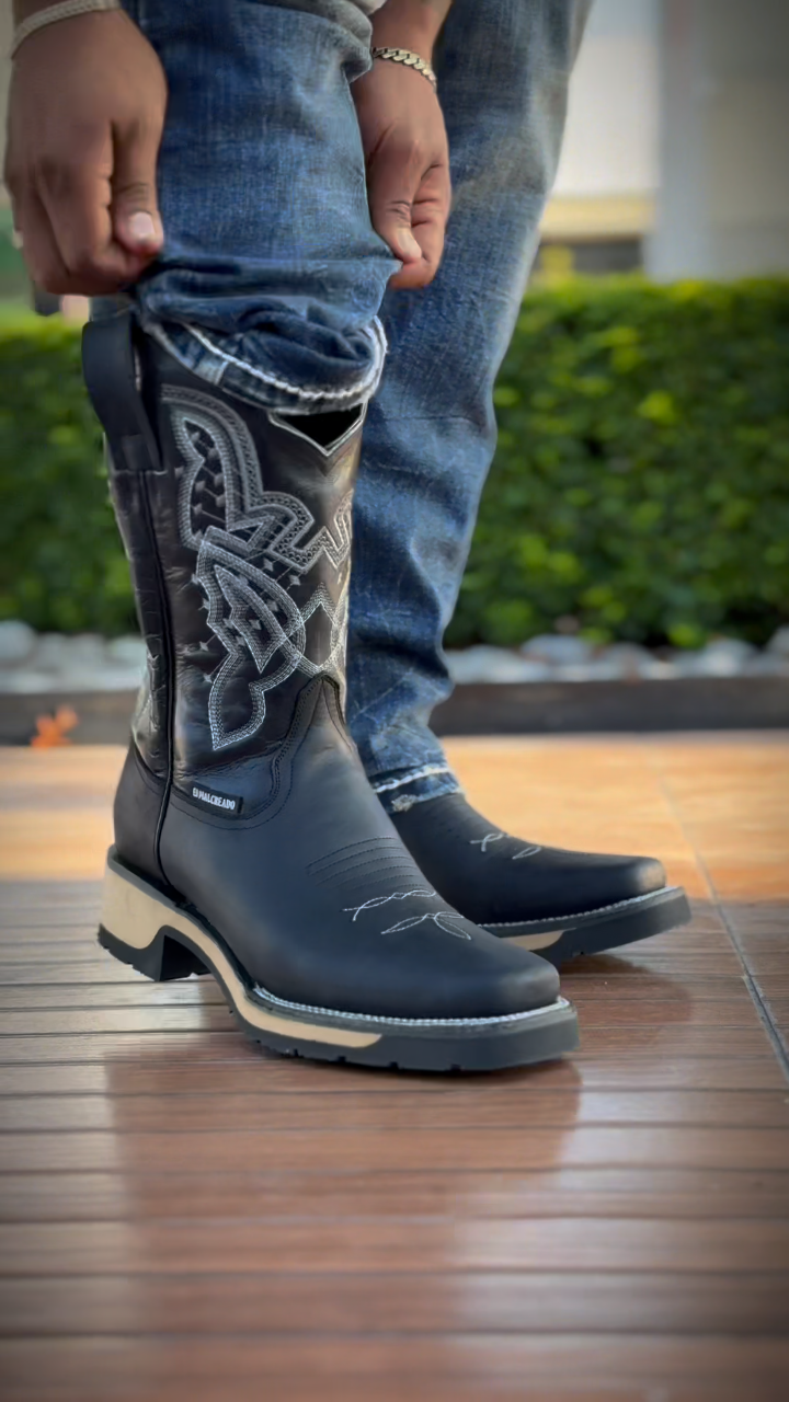 Black cowboy boots with white stitching